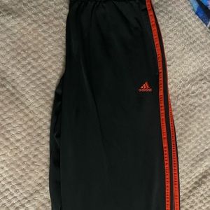 Red and black Adidas joggers